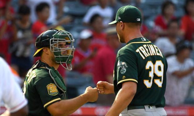 ANAHEIM, CA - AUGUST 12:  Blake Treinen #39 gets a fist pump from Josh Phegley #19 of the Oakland A...