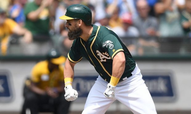 OAKLAND, CA - AUGUST 15: Nick Martini #38 of the Oakland Athletics celebrates standing on third bas...
