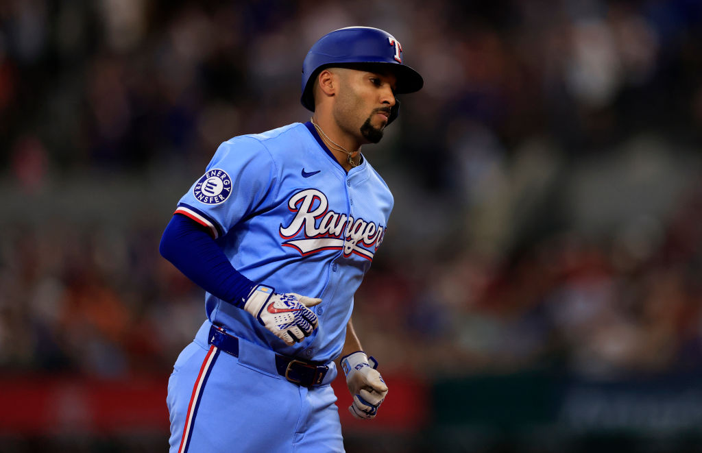 ARLINGTON, TX - JUNE 9: Marcus Semien #2 of the Texas Rangers runs the bases after hitting a two ru...
