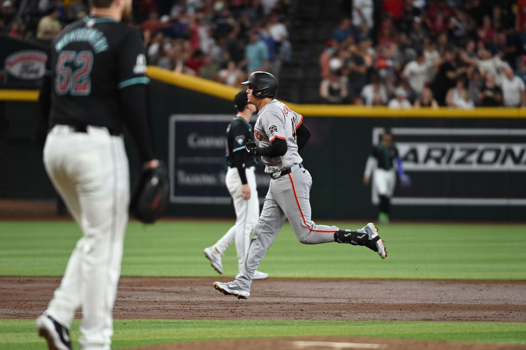PHOENIX, ARIZONA - JUNE 05: Wilmer Flores #41 of the San Francisco Giants rounds the bases after hi...